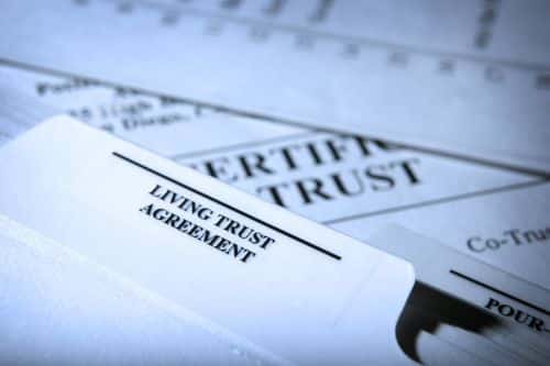 A close up of a notebook tab identified as a trust agreement. Visual concept for a legal blog discussing the benefits of a trust.