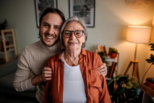 Image of a caring older mother and her adult son. Visual concept for a blog discussing the differences between power of attorney and guardianship.
