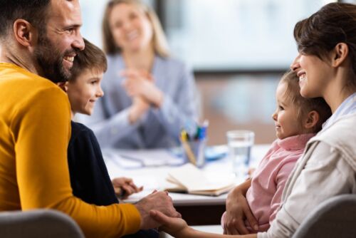 Happy parents and their children visual concept for a blog discussing estate planning for children.
